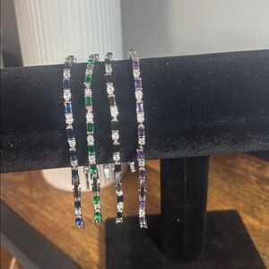 4 tennis bracelets with faux stones. Emerald/Amethyst/Sapphire/Onyx/Diamonds